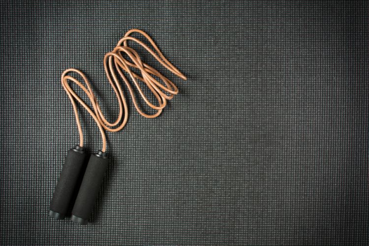 Jump rope with weights on a yoga mat